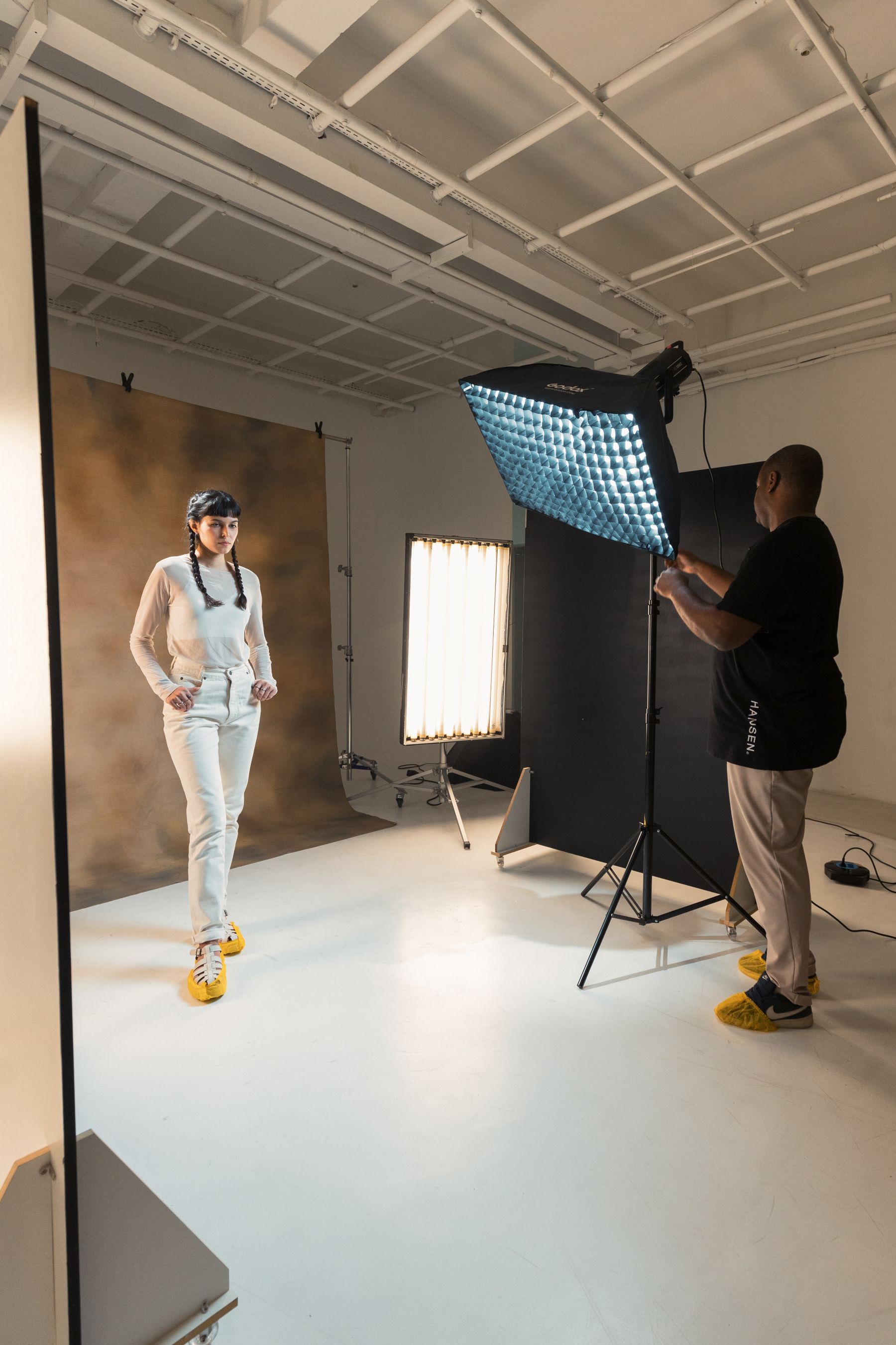 Photographer working with a subject on the studio floor